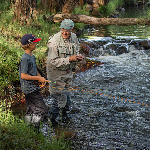 man and kid trout fishing